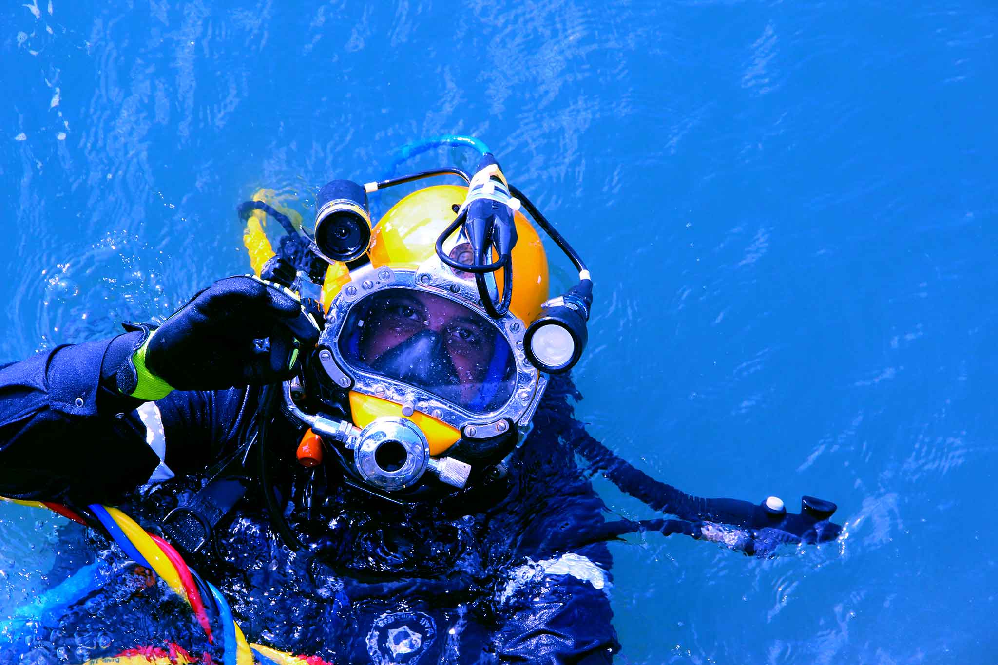 Commercial diver using Kirby Morgan helmet