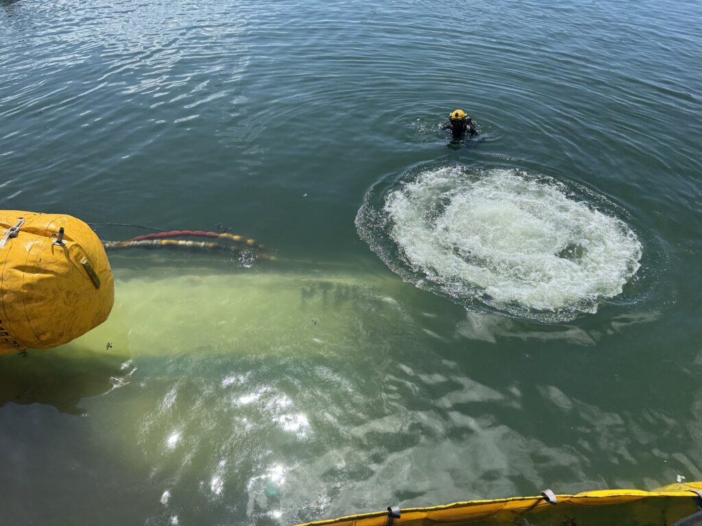 Divexpro diver working over the sunken hull during the refloating operation
