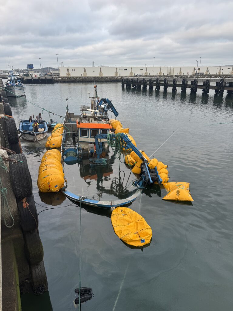 The vessel rising further, held by lift bags along both sides