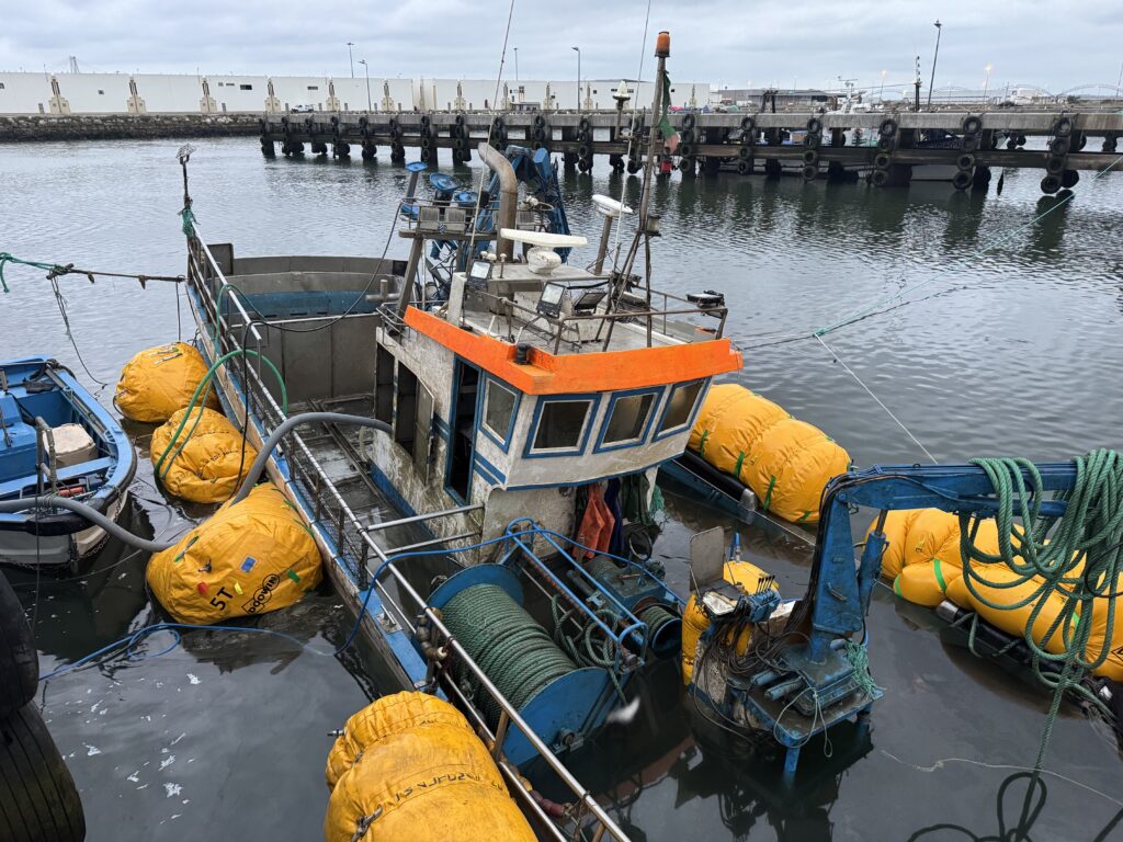 Deck and wheelhouse clear of the water, lift bags still in place